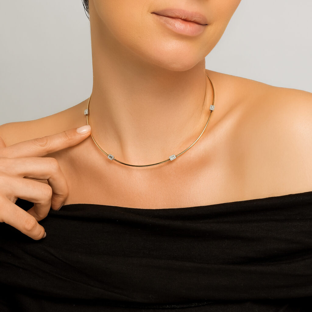 Empire Omega Necklace — diamond stations on a polished yellow gold collar, worn on neck