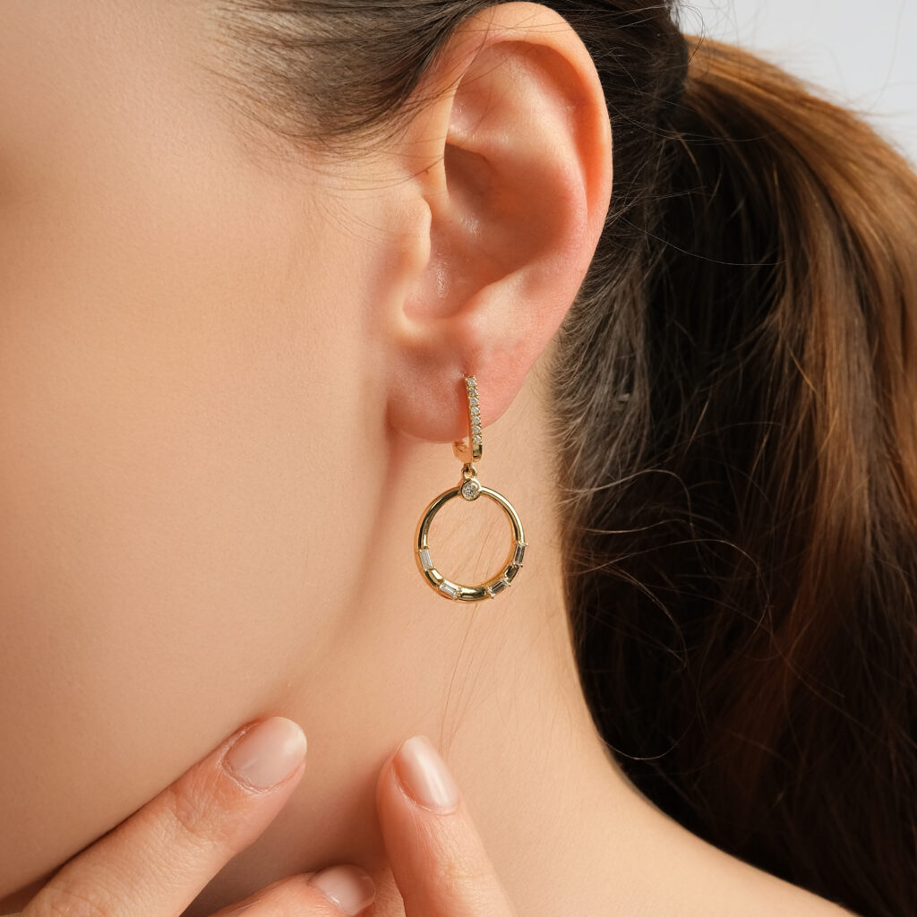 Orbit Halo Earrings — diamond-set hoops with gold circles, yellow gold, worn on ear