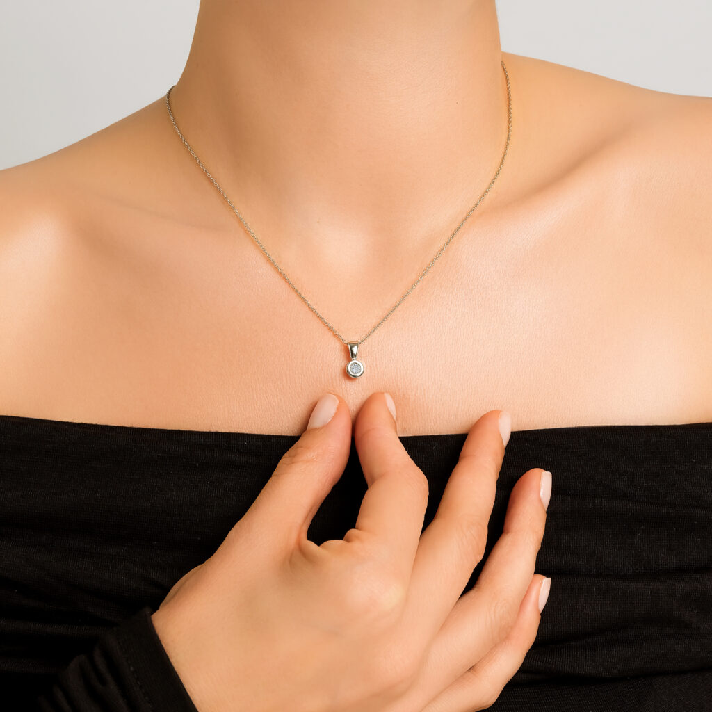 Sade Solitaire Necklace — single brilliant diamond on a white gold chain, worn on neck